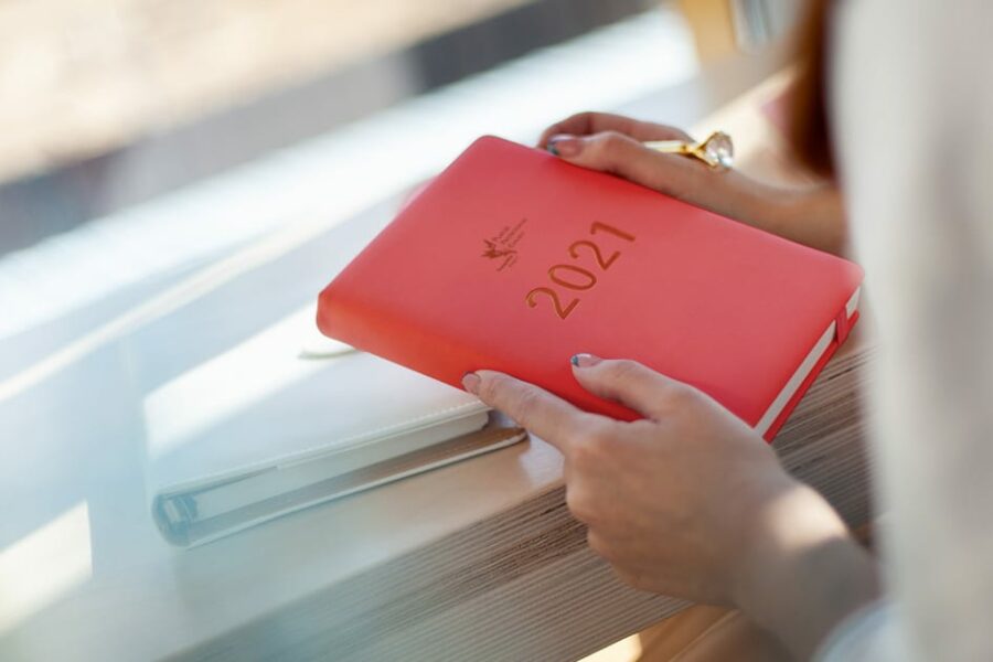 woman holding a red CPP 2021 planner
