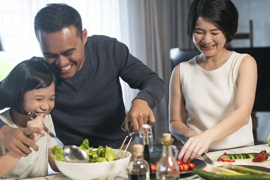 asian family preparing healthy food in the kitchen