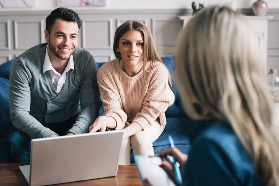 Real-estate agent shows a build project to a young couple.
