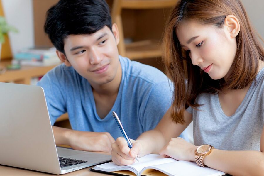 Beautiful young asian couple calculate expenses finance with laptop and planning together, woman writing notebook or note budget household, lifestyle family and business