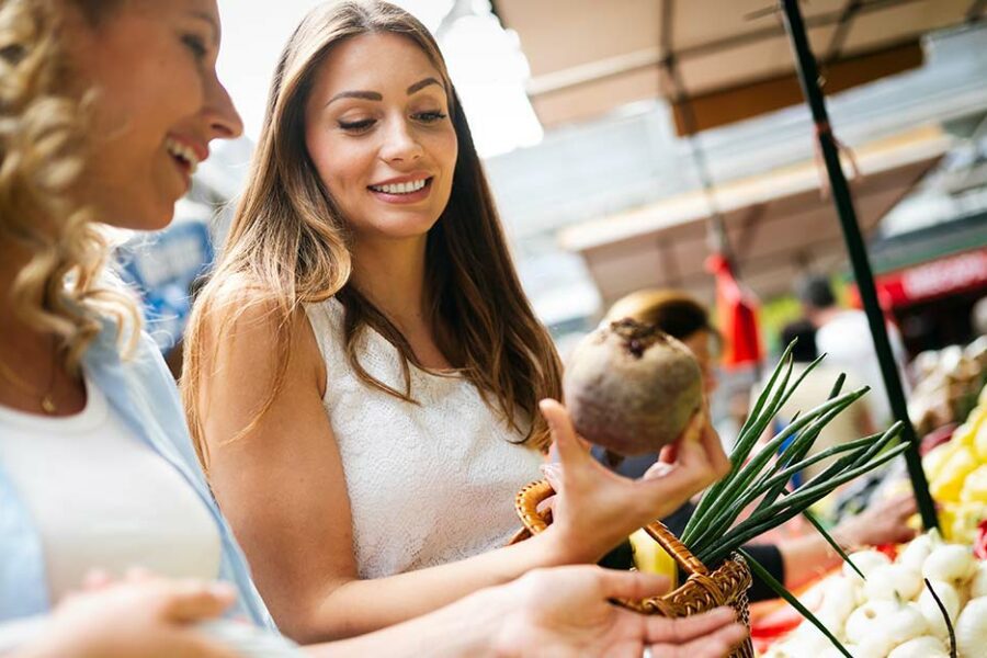 2 women shopping at a farmers market