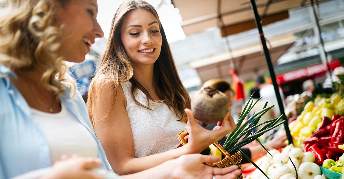 2 women shopping at a farmers market