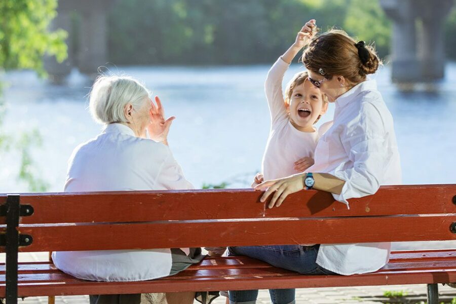 Senior woman, her adult granddaughter and great grandson in park