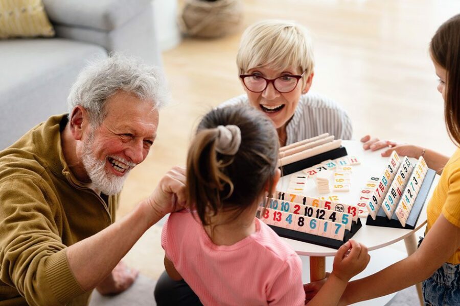 Grand daughters playing with their grandparents at home