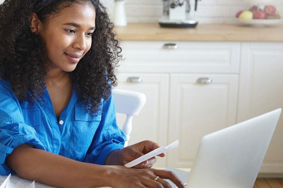 Young african adult paying off student loans and other debts