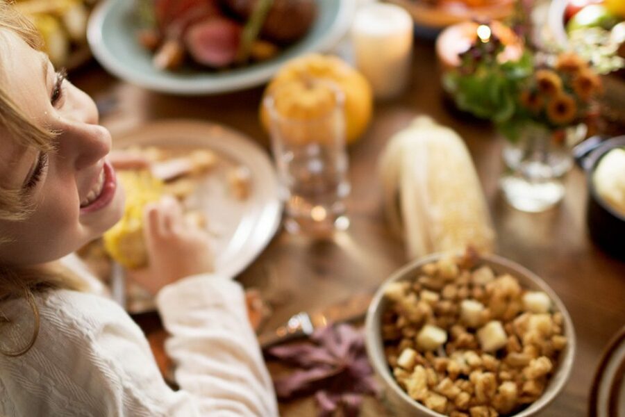 Girl enjoying Thanksgiving dinner.