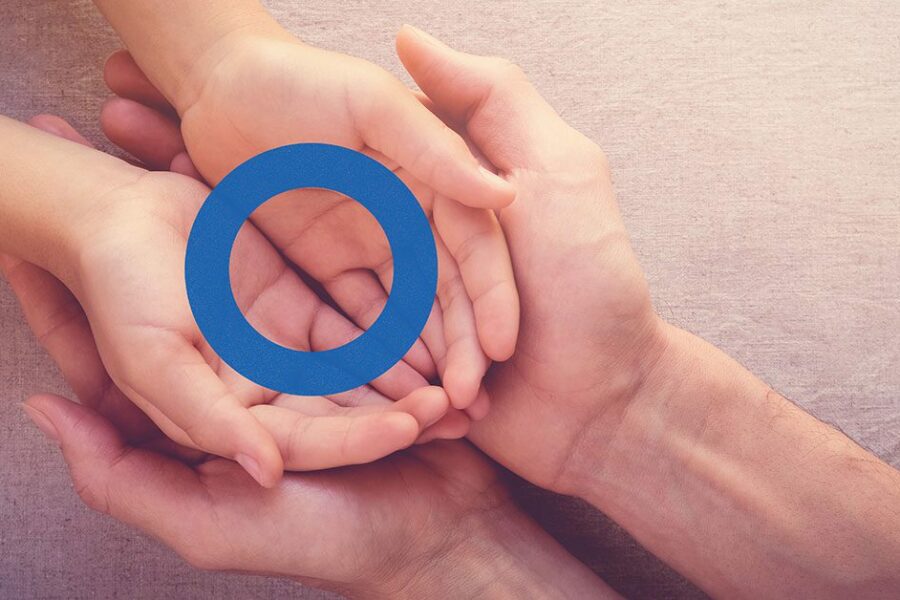 Father and Child hands together with blue circle on top
