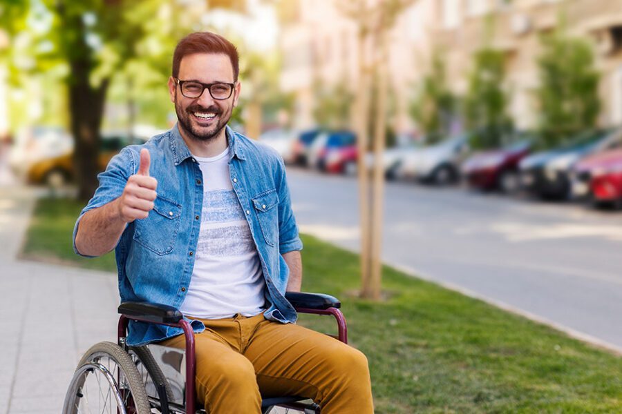 happy man on a wheelchair with his thumbs up