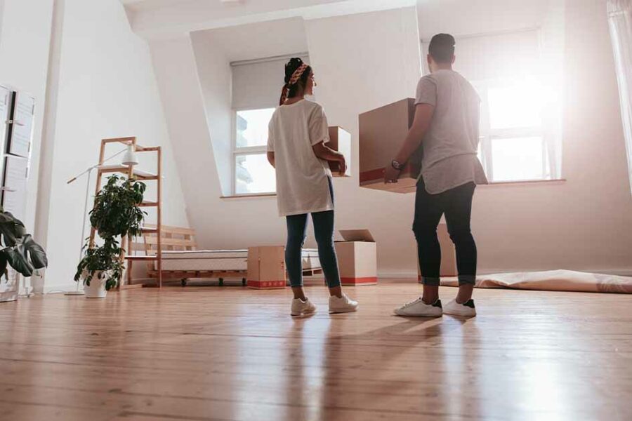 A young couple moving into their new home