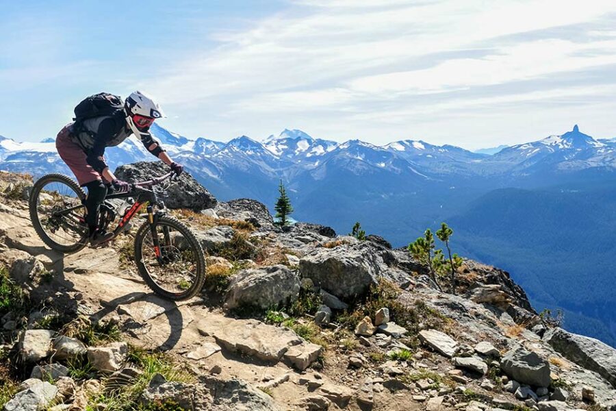 Person mountain biking on a mountain range