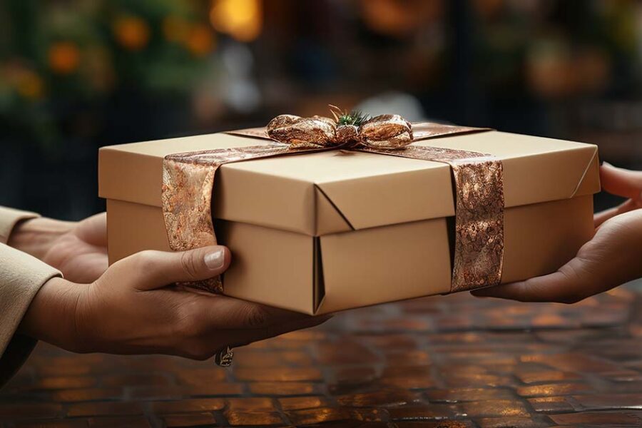 set of hands giving a present and a set of hands receiving the present