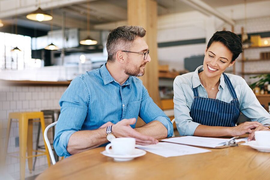 small business owner talking to an advisor on the table