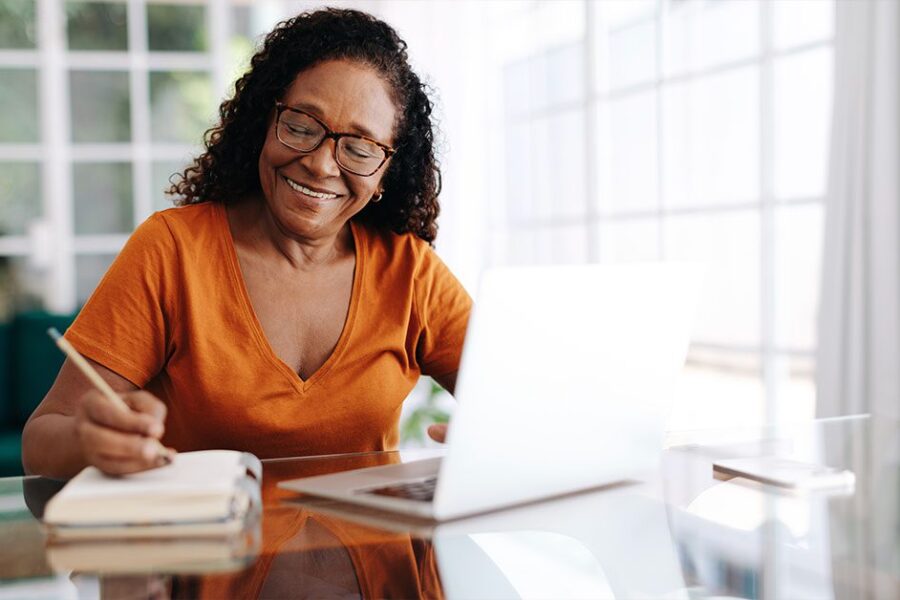 black African senior woman writing to plan ahead